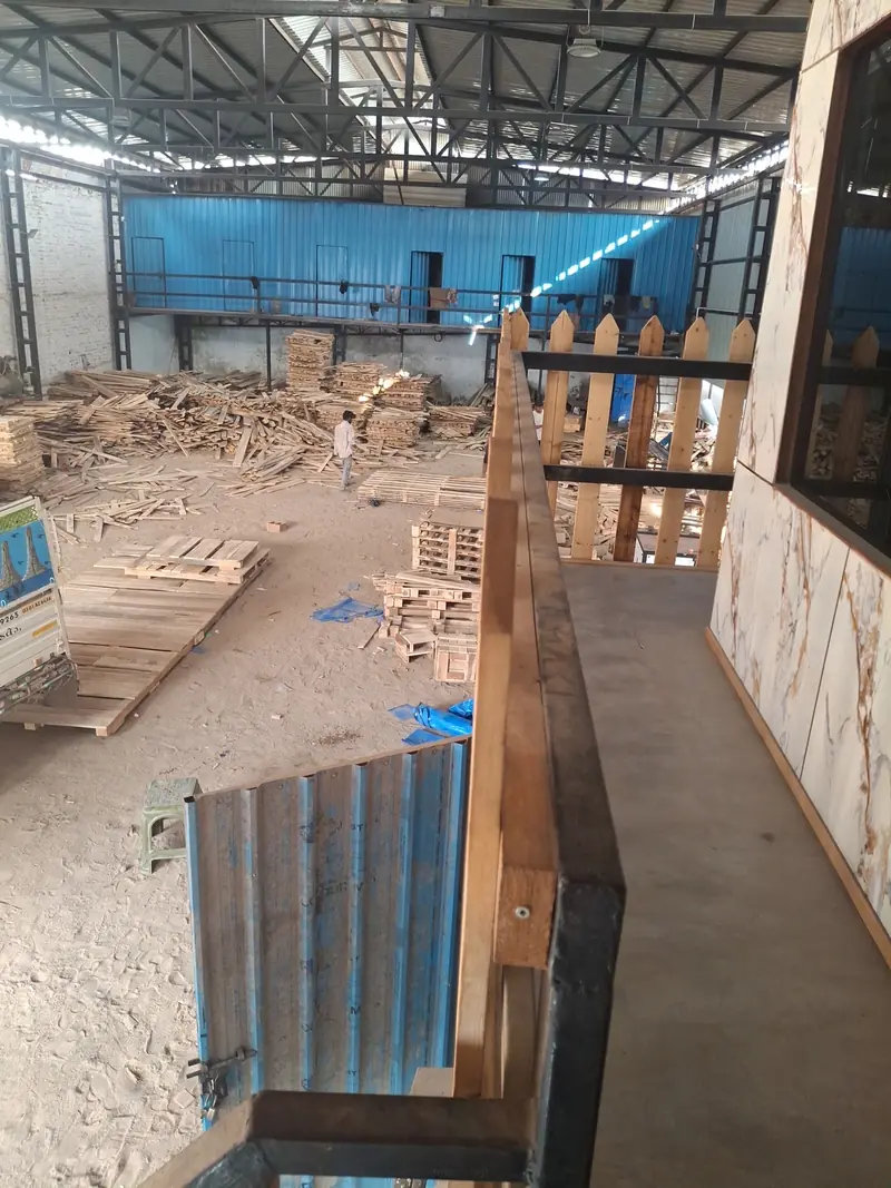 View over the Ambica shed floor at Santej with pallets and timber